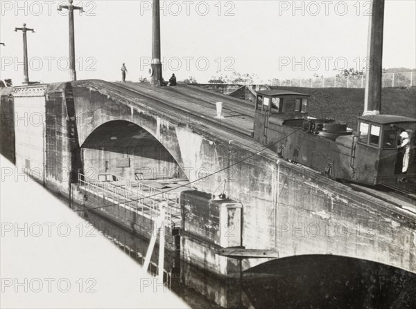 Mole on Panama Canal. A railcar runs along the top of a stone mole by the Panama Canal. Panama, circa 1931. Panama, Central America, North America .