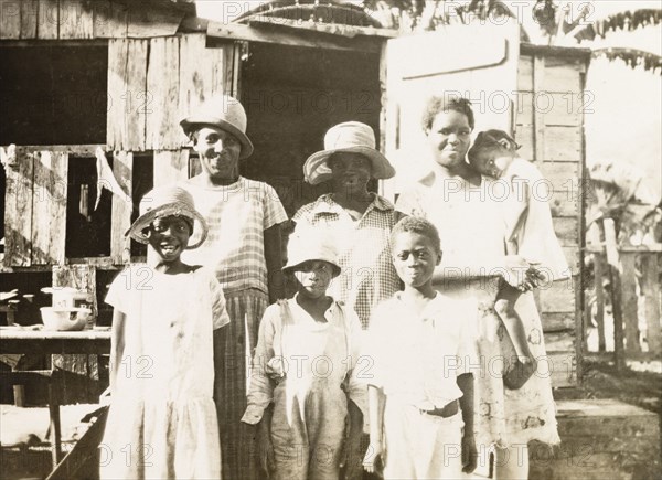 Tobagoan women and children. Three Tobagoan women and their children pose for a group portrait on a street near Man-O-War Bay. Tobago, circa 1931., Trinidad and Tobago, Trinidad and Tobago, Caribbean, North America .