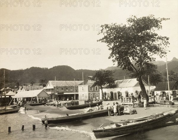 Kingstown, St Vincent. View of the seafront of the port city of Kingstown, where several long row boats are beached on the shore. Kingstown, St Vincent, circa 1931. Kingstown, St George (St Vincent and the Grenadines), St Vincent and the Grenadines, Caribbean, North America .
