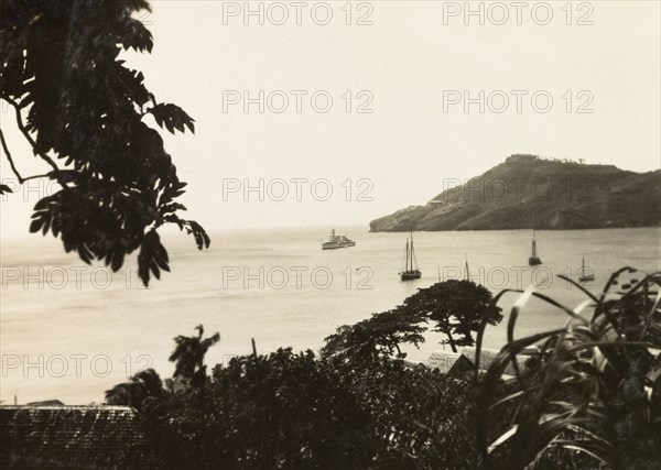 View from Kingstown, St Vincent. View from Kingstown port out to the Caribbean Sea, where several fishing boats are sailing and the HMS Dauntless is anchored. Kingstown, St Vincent, circa 1931. Kingstown, St George (St Vincent and the Grenadines), St Vincent and the Grenadines, Caribbean, North America .