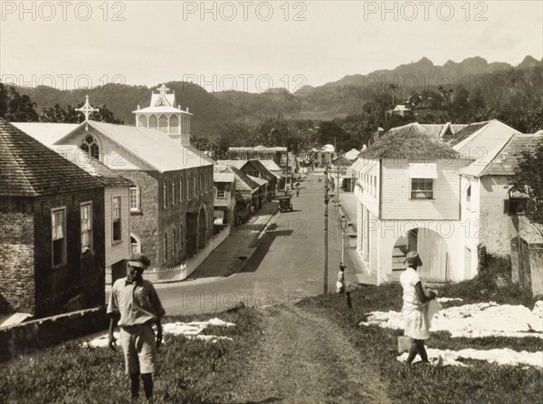 Kingstown, St Vincent. View down an colonial street in Kingstown towards the central mountain range of St Vincent Island. Kingstown, St Vincent and the Grenadines, circa 1931. Kingstown, St George (St Vincent and the Grenadines), St Vincent and the Grenadines, Caribbean, North America .