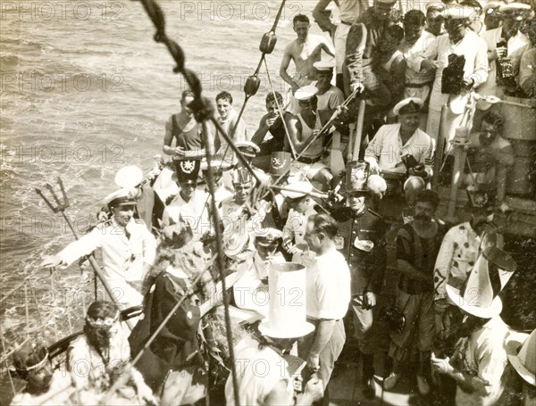 Crossing the line' ceremony. Crew members dressed in costume as King Neptune and his court for a 'crossing the line' naval initiation ceremony aboard HMS Dauntless. South Atlantic Ocean near the coast of Brazil, circa 1931., South Atlantic Ocean, South America .