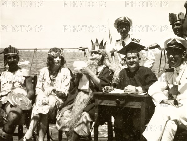 King Neptune's court. Crew members dressed in costume as King Neptune and his court for a 'crossing the line' naval initiation ceremony aboard HMS Dauntless. South Atlantic Ocean near the coast of Brazil, circa 1931., South Atlantic Ocean, South America .