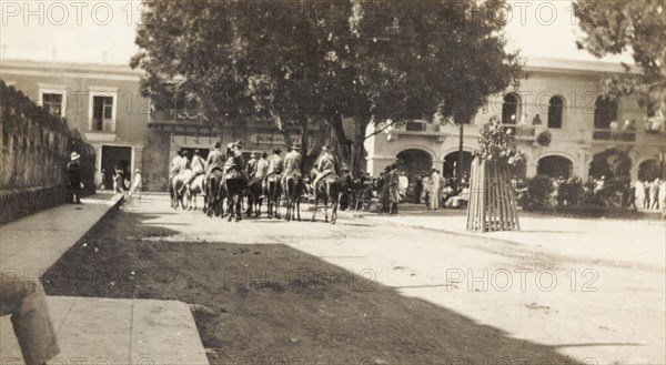 Rurales in Santo Domingo. A band of 'rurales' (Mexican rural guards) ride on horseback through a city square in Santo Domingo. Santo Domingo, Dominican Republic, circa 1913. Santo Domingo, Santo Domingo, Dominican Republic, Caribbean, North America .