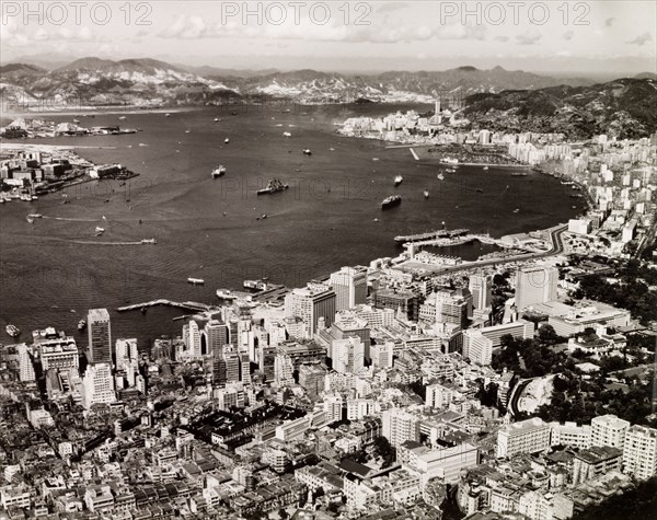 Hong Kong Island and Victoria Harbour. View across Victoria Harbour with Hong Kong Island's crowded Central District in the foreground. Hong Kong, China, 1963. Hong Kong, Hong Kong, China, People's Republic of, Eastern Asia, Asia.