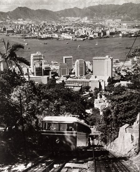 The Peak Tramway, Hong Kong. A tram runs along the Peak Tramway to the top of Victoria Peak, a tourist hotspot that commands views over Hong Kong Island's Central District, Victoria Harbour and the Kowloon peninsula. Hong Kong, China, 1963. Hong Kong, Hong Kong, China, People's Republic of, Eastern Asia, Asia.