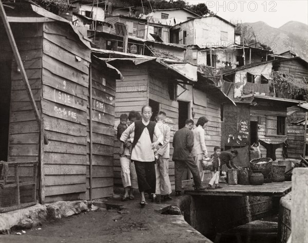 A squatter's settlement in Kowloon. A squatter's settlement in Kowloon. An original caption comments that "there are many thousands of Chinese who have no such elegant homes as these, and many thousands, who having no homes at all, live on the streets". Kowloon, Hong Kong, China, 1963. Kowloon, Hong Kong, China, People's Republic of, Eastern Asia, Asia.