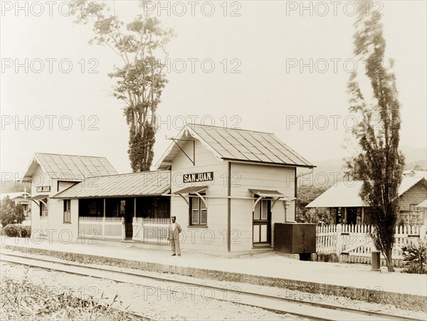 San Juan railway station, Trinidad. A solitary figure waits on the platform at the newly completed San Juan railway station on the Trinidad Government Railway line. San Juan, Trinidad, circa 1912., Trinidad and Tobago, Trinidad and Tobago, Caribbean, North America .