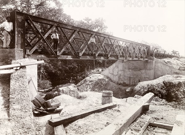 Railway bridge over Aripo River, Trinidad. A railway bridge under construction by Trinidad Government Railways over the Aripo River on the Sangre Grande extension line. Trinidad, circa 1912., Trinidad and Tobago, Trinidad and Tobago, Caribbean, North America .