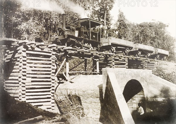 Locomotive travelling across culvert 'No. 35' . A steam locomotive travels across culvert 'No. 35' on an extended section of railway line built by Trinidad Government Railways to connect Rio Claro to the rail network. Trinidad, 11 September 1913., Trinidad and Tobago, Trinidad and Tobago, Caribbean, North America .