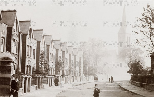 Lodge Road, West Croydon. View past a row of houses on Lodge Road in West Croydon, to the tall spire of a church. Croydon, England, circa 1910. Croydon, London, Greater, England (United Kingdom), Western Europe, Europe .