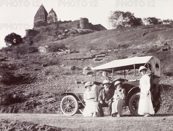 Road trip, India. James and Minnie Murray pose beside their parked motor car with two friends near the ruins of a temple, during a car trip from Calcutta (Kolkata) to Ranchi. India, circa 1916. India, Southern Asia, Asia.