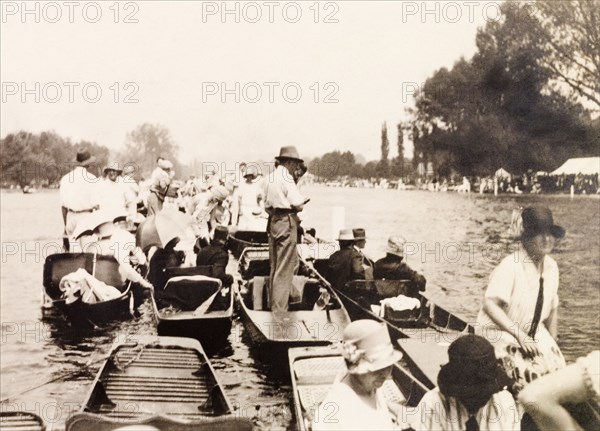 Henley Royal Regatta, 1929. Spectators gather on punts on the River Thames to watch a boat race at the Henley Royal Regatta. Henley-on-Thames, England, July 1929. Henley on Thames, Oxfordshire, England (United Kingdom), Western Europe, Europe .