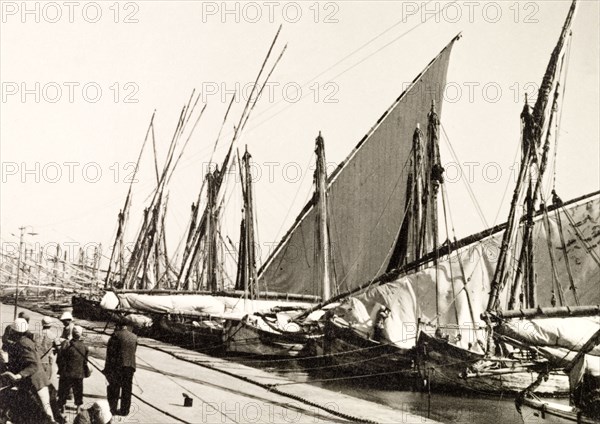Docks on Suez Canal. Rows of sail boats are moored at docks on the Suez Canal. Suez, Egypt, 1930. Suez, Suez, Egypt, Northern Africa, Africa.