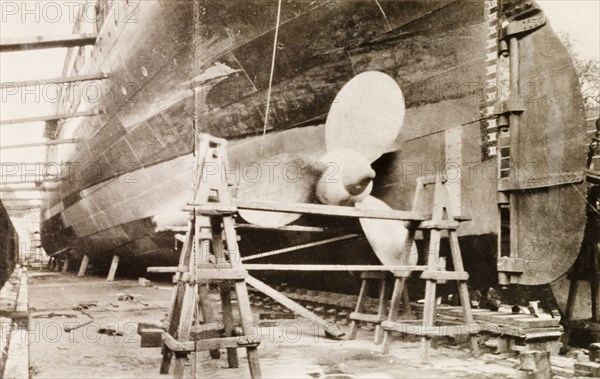 Ship at Kidderpore dry dock. View of a large ship dry-docked at Kidderpore dock, supported by a series of timber beams. Calcutta (Kolkata), India, 1931. Kolkata, West Bengal, India, Southern Asia, Asia.