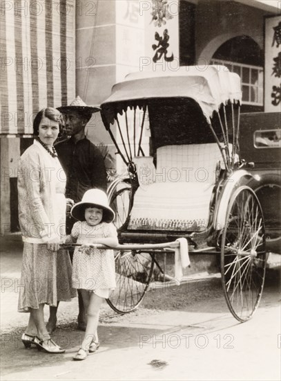 Posing with a rickshaw, Kuala Lumpur. A British woman and her daughter pose with a rickshaw during a visit to Kuala Lumpur. Kuala Lumpur, Malay (Malaysia), 1931. Kuala Lumpur, Kuala Lumpur, Malaysia, South East Asia, Asia.