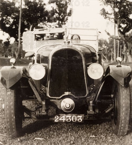 Posing in a Avion Voisin car, Calcutta. British colonist Noel Stokes sits in his Avion Voisin car with a female companion, as they prepare to embark on a journey along the Grand Trunk Road from Calcutta to Ranchi. Calcutta (Kolkata), India, June 1932. Kolkata, West Bengal, India, Southern Asia, Asia.