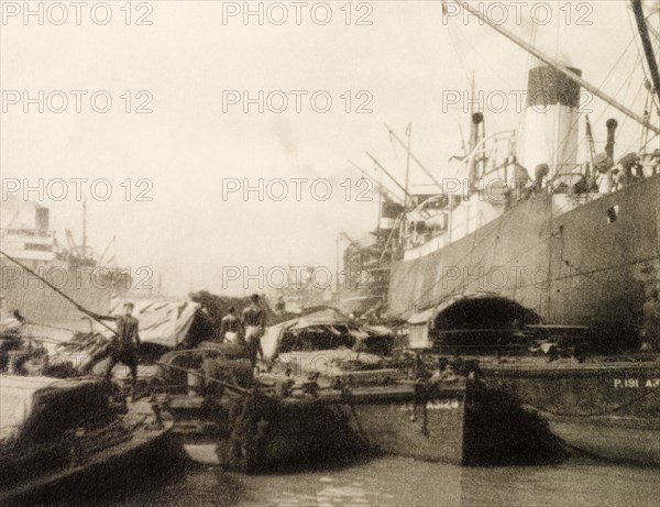 Vessels at Calcutta docks. River barges butt up against huge steamships at Calcutta docks on the Hooghly River. Calcutta (Kolkata), India, circa 1930. Kolkata, West Bengal, India, Southern Asia, Asia.