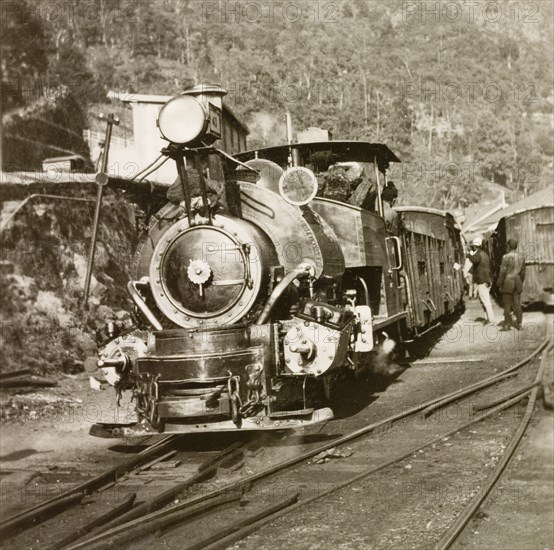 Steam train on the Darjeeling Railway. A steam locomotive travels along the narrow-gauge tracks of the Darjeeling Himalayan Railway. Darjeeling, India, April 1935. Darjeeling, West Bengal, India, Southern Asia, Asia.