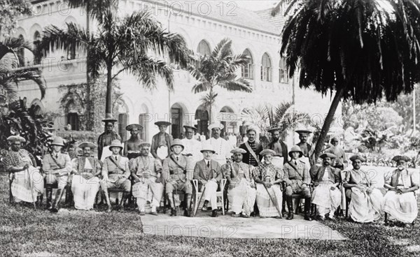 Ceylon Police. Group portrait of uniformed British police officers and Kandyan chiefs in traditional regalia, posing to commemorate the departure of the Superintendent of Police, Mr H. Thornhill. Ceylon (Sri Lanka), circa 1927. Sri Lanka, Southern Asia, Asia.
