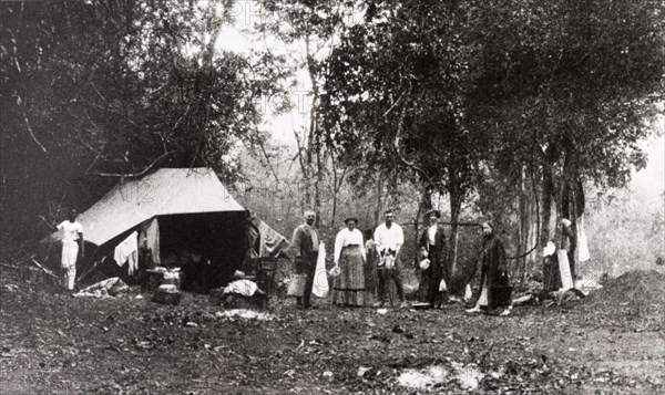 Hunting party camp, Ceylon. A group of Europeans attending an elephant kraal or drive pose at their camp site located in a jungle clearing. Ceylon (Sri Lanka), 1912. Sri Lanka, Southern Asia, Asia.