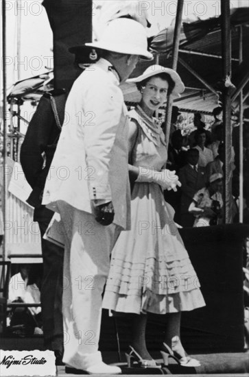 Queen Elizabeth II in Aden. Queen Elizabeth II chats with a uniformed dignitary, possibly the Governor of Aden, Sir Tom Hickinbotham, during her visit to Aden as part of her royal tour of the Commonwealth from November 1953 to May 1954. Aden, Yemen, 27 April 1954. Aden, Adan, Yemen, Middle East, Asia.