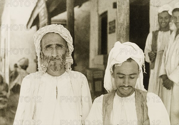 Portrait of two Arab men. Portrait of two Arab men, one young and one elderly, wearing traditional headscarves on a street in Zanzibar. Probably Stone Town, Zanzibar (Unguja, Tanzania), 1947., Zanzibar Urban/West, Tanzania, Eastern Africa, Africa.