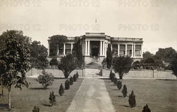 Prime Minister of Indore's palace. View along an avenue of newly-planted trees to the pillared facade of the Prime Minister of Indore's palace. Indore, Indore State (Madhya Pradesh), India, 2 August 1928. Indore, Madhya Pradesh, India, Southern Asia, Asia.