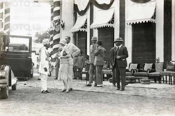 Sir Bertrand and Lady Glancy at Jaora. Sir Bertrand and Lady Glancy chat wth an Indian dignitary as they await the arrival of Lord Irwin, Viceroy of India, at the Nawab of Jaora's palace. Jaora State, Malwa Agency (Madhya Pradesh), India, 3 August 1928., Madhya Pradesh, India, Southern Asia, Asia.