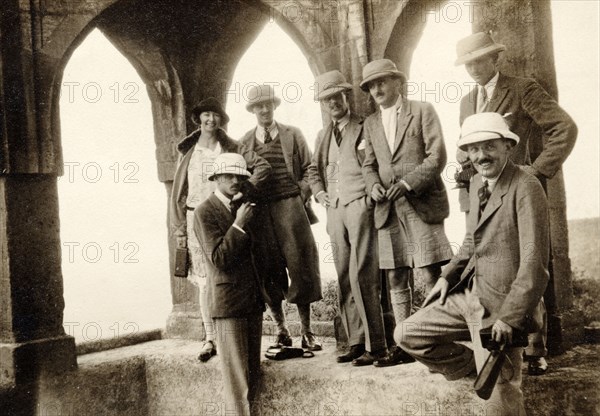 Officers of the West Yorkshire Regiment. Lieutenant George W.H. Innes of the West Yorkshire Regiment (fourth from left) poses with fellow officers and companions under the arches of an Indian temple or ruin. India, 1928. India, Southern Asia, Asia.