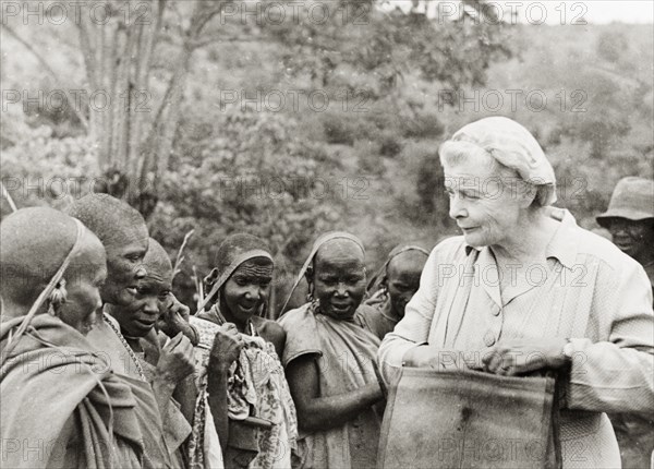 Nellie Grant meets Kikuyu women. Nellie Grant, the wife of settler farmer Jos Grant and mother of Elspeth Huxley (nee Grant), meets a group of Kikuyu women described as "squatter's wives" on her Njoro farm. Njoro, Kenya, circa 1947. Njoro, Rift Valley, Kenya, Eastern Africa, Africa.