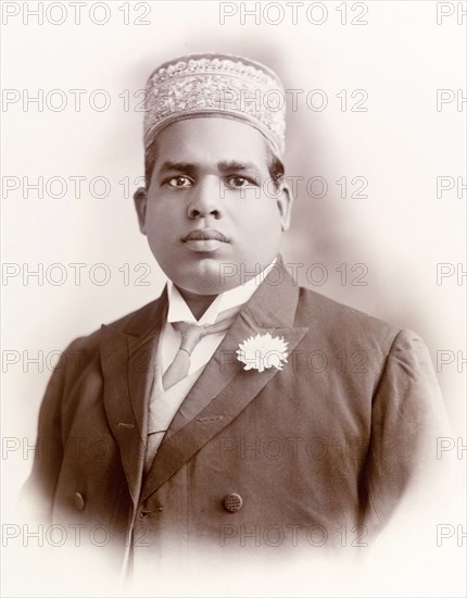 Elaya Rajah of Nilambur. Studio portrait of the Elaya Rajah (heir apparent) of Nilambur, dressed in a Western-style suit with an embroidered 'kufi' (hat). Nilambur, Malabar District (Kerala), India, 1908., Kerala, India, Southern Asia, Asia.