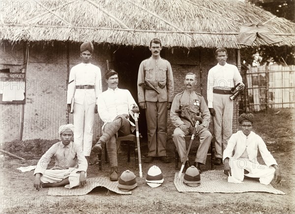 Police Guard, Edakkara. Group portrait of officers of the Police Guard, who accompanied Sir Arthur Lawley, Governor of Madras, and the Elaya Rajah (heir apparent) of Nilambur on a hunting expedition in the Nilgiri Hills. Edakkara, Malabar District (Kerala), India, March 1908., Kerala, India, Southern Asia, Asia.