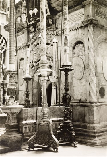 Tomb of Jesus, Jerusalem. View of the large, elaborate candlesticks flanking the entrance to the Tomb of Jesus inside the Church of the Holy Sepulchre, a Christian church believed to be built over Calvary (Golgotha), the hill on which Jesus was crucified. Jerusalem, British Mandate of Palestine (Israel), circa 1942. Jerusalem, Jerusalem, Israel, Middle East, Asia.