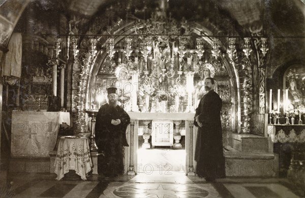 Calvary Altar, Jerusalem. Two monks stand beside the ornate Calvary Altar in the Church of the Holy Sepulchre, a Christian church believed to be built over Calvary (Golgotha), the hill on which Jesus was crucified. Jerusalem, British Mandate of Palestine (Israel), circa 1942. Jerusalem, Jerusalem, Israel, Middle East, Asia.