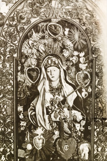 The Blessed Virgin Mary. A painting of the Blessed Virgin Mary inside the Church of the Holy Sepulchre, a Christian church believed to be built over Calvary (Golgotha), the hill on which Jesus was crucified. Jerusalem, British Mandate of Palestine (Israel), circa 1942. Jerusalem, Jerusalem, Israel, Middle East, Asia.