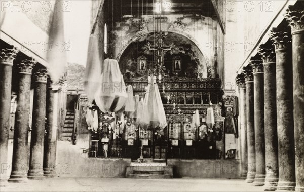 Altar of Church of the Nativity. Interior view of the altar inside the Church of the Nativity, a Christian church traditionally believed to be built over Jesus' birthplace. Bethlehem, British Mandate of Palestine (West Bank, Middle East), circa 1942. Bethlehem, West Bank, West Bank (Palestine), Middle East, Asia.