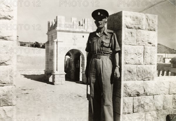 Policeman posing by chapel, Nazareth. Mr R. Denbeigh, a British police officer serving in Palestine, poses outside a small Christian chapel while on patrol on the town of Nazareth. Nazareth, British Mandate of Palestine (Israel), circa 1942. Nazareth, North (Israel), Israel, Middle East, Asia.
