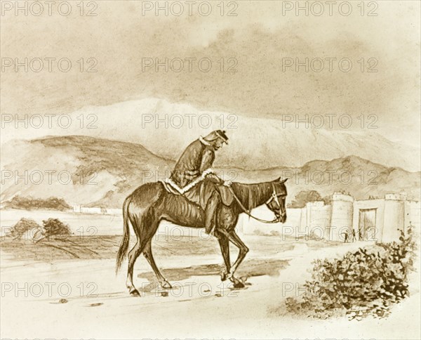 A weary British soldier. An illustration depicts a scene from the Indian Mutiny and Rebellion (1857-58). A weary British soldier rides an emaciated horse towards a large fortress in the distance. India, circa 1857. India, Southern Asia, Asia.