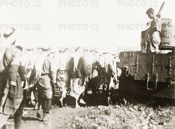 Marching Palestinian Arabs to a detention centre. British soldiers march a group of Palestinian Arabs to a detention centre for questioning. During the period of the Great Uprising (1936-39), an additional 20,000 British troops were deployed to Palestine in an attempt to clamp down on Arab dissidence. British Mandate of Palestine (Middle East), 1938., Middle East, Asia.