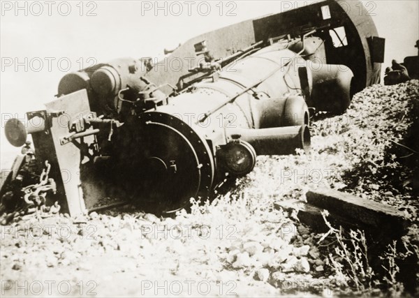 Derailed steam locomotive at Ras el Ain. A steam locomotive lies upturned on a railway embankment, derailed in a sabotage attack by Palestinian Arab dissidents during the Great Uprising (1936-39). Ras el Ain, British Mandate of Palestine (Israel), circa 1938. Israel, Middle East, Asia.