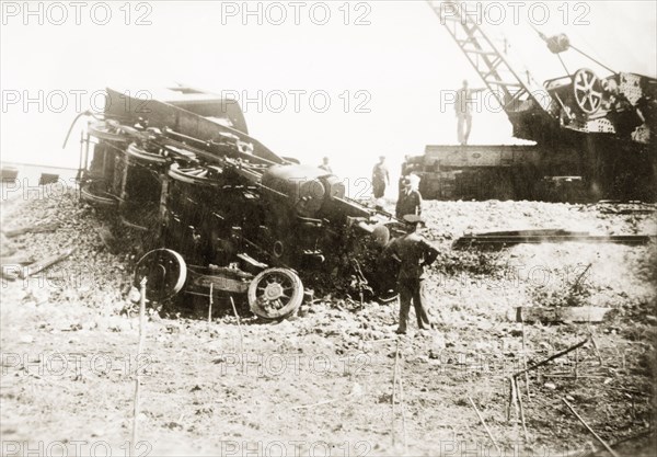 Removing a crashed locomotive, Ras el Ain. Railway officials prepare to lift a derailed steam locomotive with a crane following a sabotage attack by Palestinian Arab dissidents during the Great Uprising (1936-39). Ras el Ain, British Mandate of Palestine (Israel), circa 1938. Israel, Middle East, Asia.