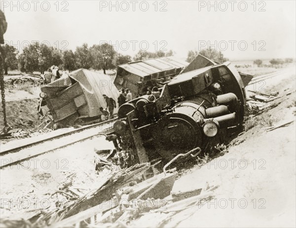 Derailed steam locomotive at Lydda. A steam locomotive lies upturned on a railway embankment, derailed in a sabotage attack by Palestinian Arab dissidents during the Great Uprising (1936-39). Lydda, British Mandate of Palestine (Lod, Israel), circa 1938. Lod, Central (Israel), Israel, Middle East, Asia.