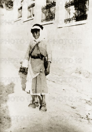 Portrait of a Arab boy, Palestine. An Arab boy in traditional Palestinian dress poses for his portrait on a city street. British Mandate of Palestine (Middle East), circa 1938., Middle East, Asia.
