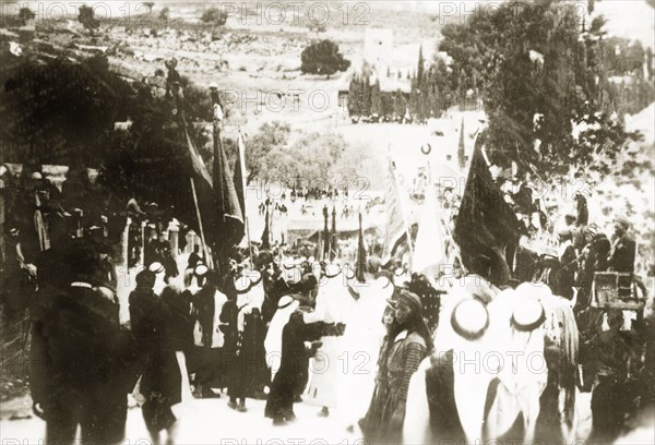 Nebi Musa procession in Ramallah. Muslim pilgrims bearing flags take part in a Nebi Musa procession: an annual pilgrimage made by Palestinian Muslims to Nebi Musa near Jericho, the supposed burial place of Moses. Ramallah, British Mandate of Palestine (West Bank, Middle East), circa 1938. Ramallah, West Bank, West Bank (Palestine), Middle East, Asia.