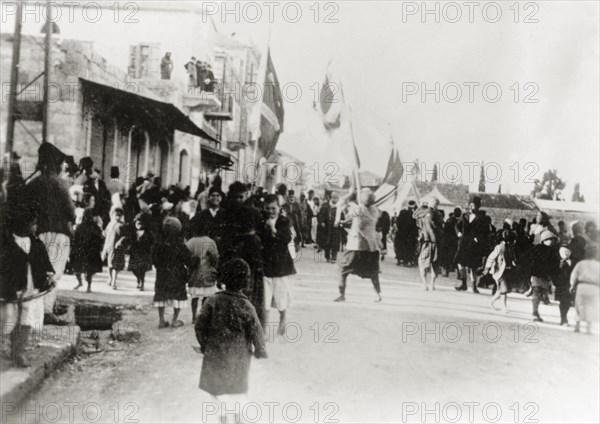 Nebi Musa procession in Ramallah. Muslim pilgrims bearing flags take part in a Nebi Musa procession: an annual pilgrimage made by Palestinian Muslims to Nebi Musa near Jericho, the supposed burial place of Moses. Ramallah, British Mandate of Palestine (West Bank, Middle East), circa 1938. Ramallah, West Bank, West Bank (Palestine), Middle East, Asia.