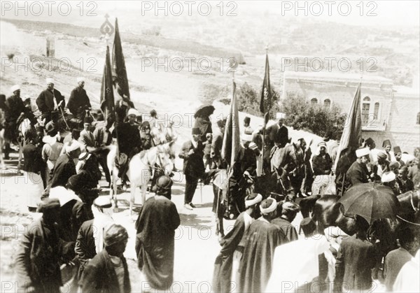 Nebi Musa procession in Ramallah. Muslim pilgrims bearing flags take part in a Nebi Musa procession: an annual pilgrimage made by Palestinian Muslims to Nebi Musa near Jericho, the supposed burial place of Moses. Ramallah, British Mandate of Palestine (West Bank, Middle East), circa 1938. Ramallah, West Bank, West Bank (Palestine), Middle East, Asia.