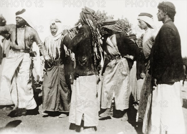 Dancing during a Nebi Musa procession. Muslim pilgrims dance to pipe music during a Nebi Musa procession: an annual pilgrimage made by Palestinian Muslims to Nebi Musa near Jericho, the supposed burial place of Moses. Ramallah, British Mandate of Palestine (West Bank, Middle East), circa 1938. Ramallah, West Bank, West Bank (Palestine), Middle East, Asia.