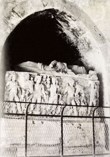 Carved stone sarcophagus, Palestine. A carved stone sarcophagus, decorated with an effigy and a frieze of figures, lies within an arched vault. British Mandate of Palestine (Middle East), circa 1938., Middle East, Asia.