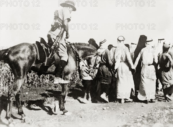 Escorting Arab detainees, Palestine. A mounted British soldier escorts a group of Palestinian Arab men along a rural road, after detaining them at 'Windy Corner'. During the period of the Great Uprising (1936-39), an additional 20,000 British troops were deployed to Palestine in an attempt to clamp down on Arab dissidence. British Mandate of Palestine (Middle East), 1938., Middle East, Asia.